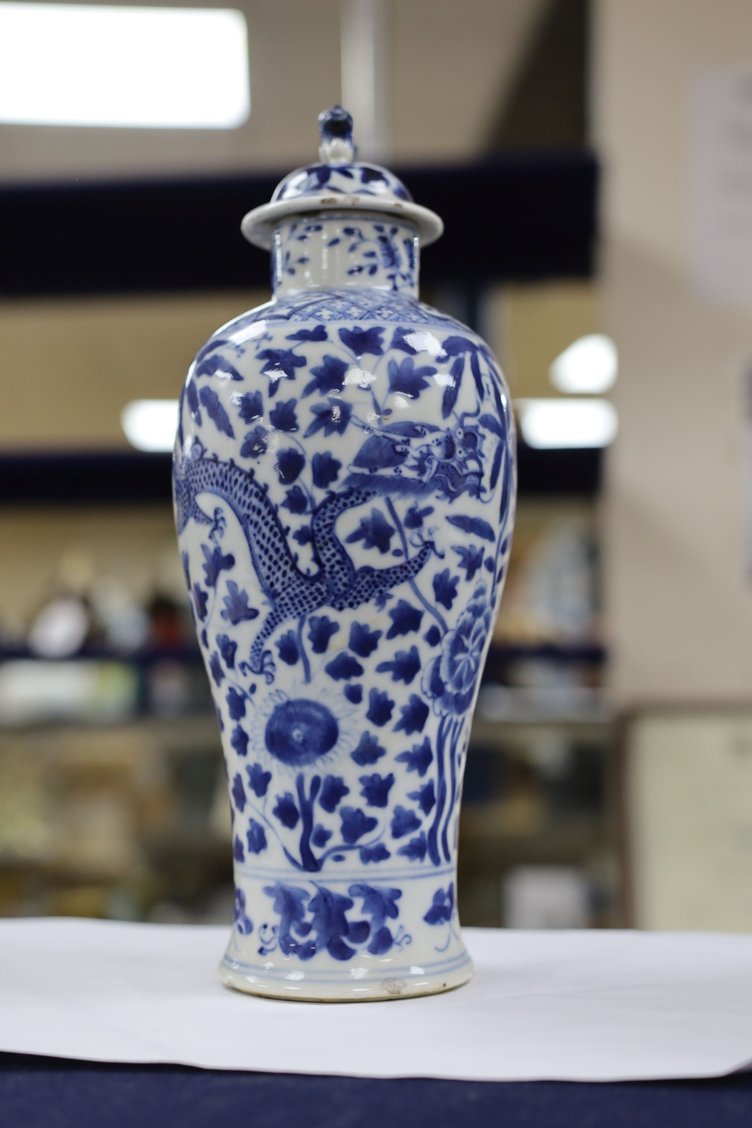 A pair of Chinese blue and white dragon vases and covers, circa 1900. 28cm